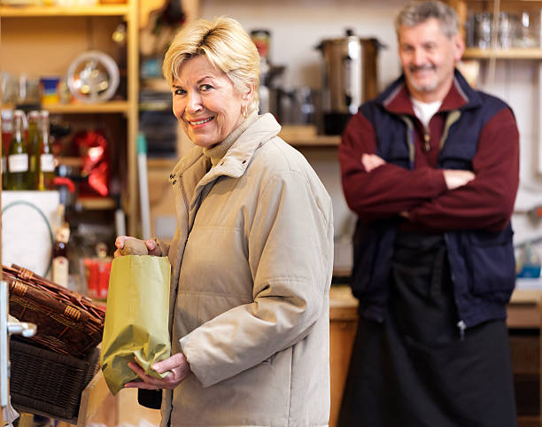 Female customer shopping at a Green Grocer Senior female customer shopping at a small green grocer in the Moabit section of Berlin. moabit stock pictures, royalty-free photos & images