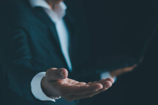 istock Close-up of a businessman using a smartphone Point and open your hand 1724403994
