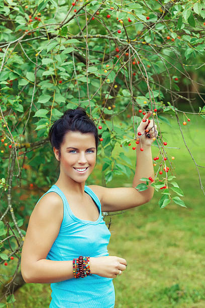 istock Young woman standing in front of cherry tree 172440527