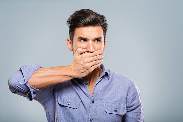 istock Young man covering his mouth 172441615