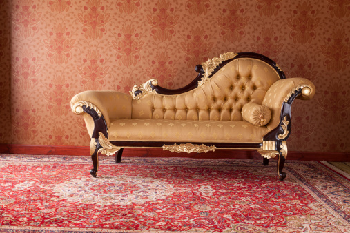 An ornate chaise longue in an upper class drawing room.