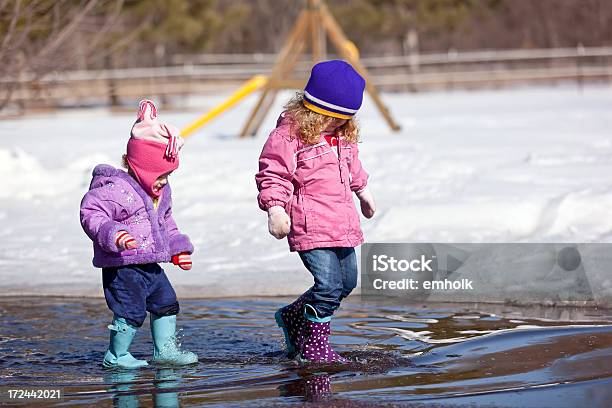 Dziewczęta Grają W Spring Kałuża - zdjęcia stockowe i więcej obrazów Śnieg - Śnieg, 12-17 miesięcy, 12-23 miesięcy