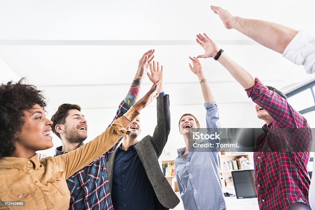 Young Business People Showing Team Spirit Group of young business people showing team spirit. Above Stock Photo