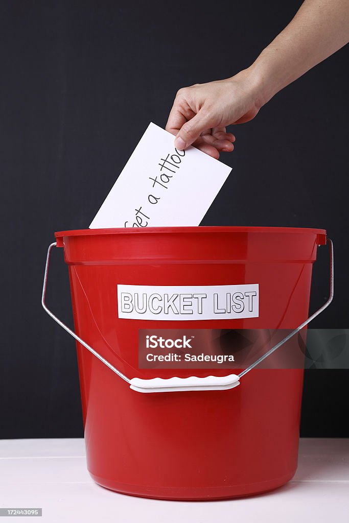 Bucket List Unrecognizable person dropping a note in a bucket listSome other related images: Aspirations Stock Photo