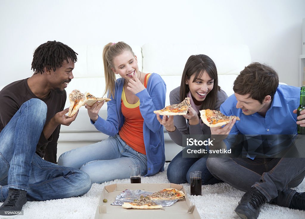 Friends having fun. Friends having fun eating pizza indoors together.See more FRIENDS indoors having FUN. Click on images below for lightbox. 20-24 Years Stock Photo