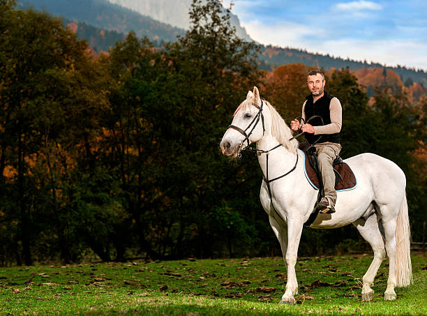 istock man with his horse 172443335