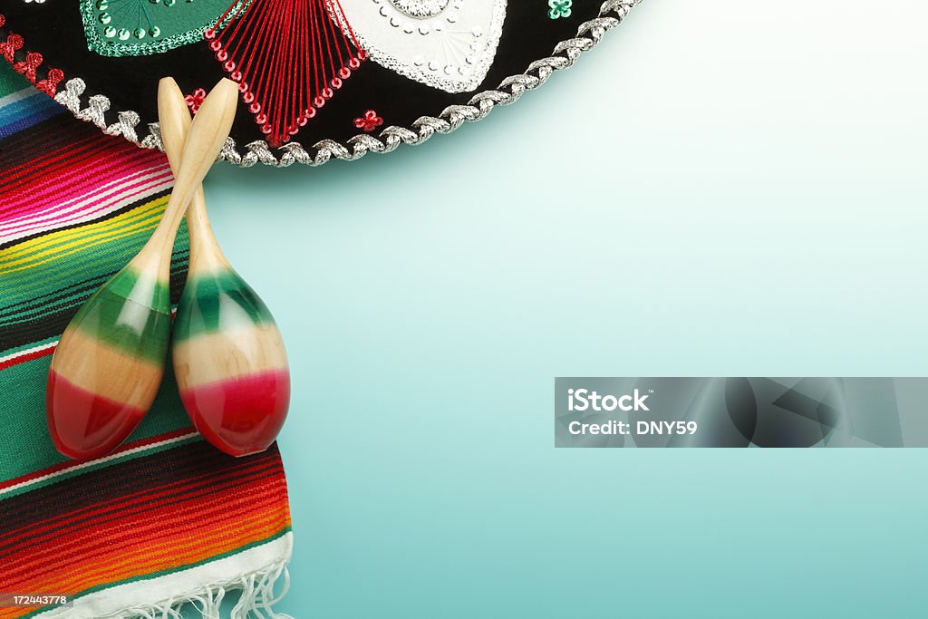 Maracas Sombrero and Mexican Blanket "Festive sombrero, a pair of maracas, and a traditional Mexican blanket on a turquoise background." Mexican Culture Stock Photo