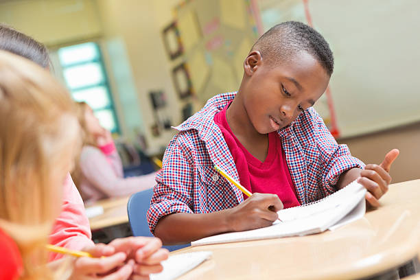 istock Kindergarten or Preschool age boy writing in public school classroom 172444270