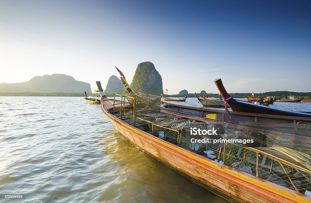 Long Tail boat sits in the beautiful beach A Long Tail boat in the beautiful Thailand Agriculture Stock Photo