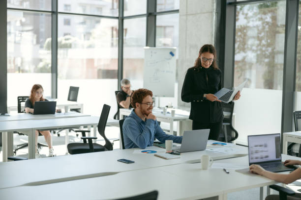 istock Business people working with laptops in office on colleagues background. Teamwork concept 1724444560