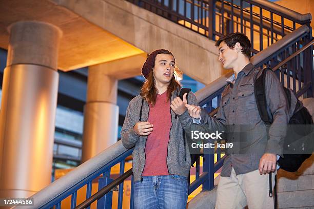 Teenage Friends Going Down Stairs Stock Photo - Download Image Now - Candid, 16-17 Years, Males