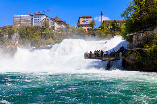 Neuhausen am Rheinfall, Switzerland - April 19, 2022: People looking at Rhine Falls from observation point, Switzerland