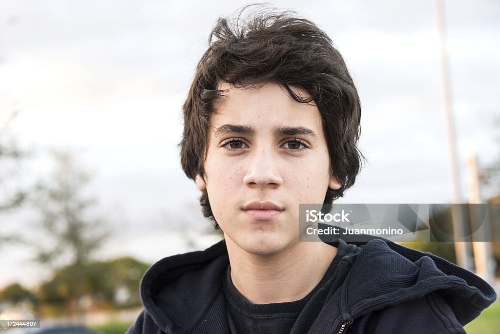 Pensive Teenager Pensive teenage boy looking at the camera Teenager Stock Photo
