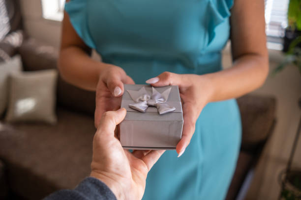 istock A man presents a gift to a woman. 1724448300