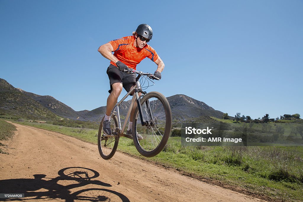 Mountain Biker Jumping Mountain biker on a nature trail jumping. Poway, California. Activity Stock Photo