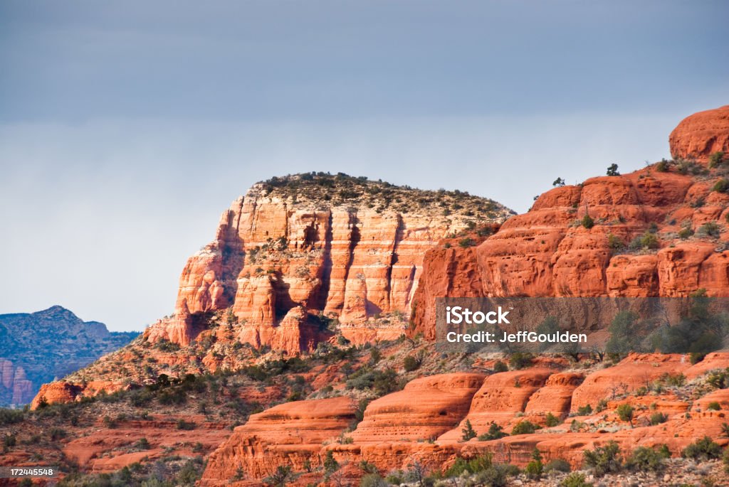 Lee Mountain at Sunset The American Southwest has some amazing landscapes, especially the rock formations. In the late evening, as the sun sets, the red rocks take on an even more colorful glow. This view of Lee Mountain was taken from the Courthouse Butte Trail in Coconino National Forest, Arizona, USA. Arid Climate Stock Photo