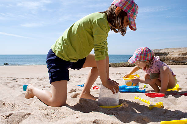 istock Girls playing with sand at the beach 172445605