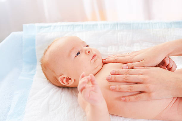 istock Mother massaging baby 172445686