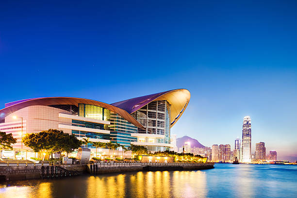 Hong Kong Convention and Exhibition Center and Skyline in background at twilight.