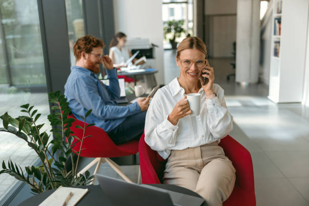istock Businesswoman talking on phone with client while working on laptop in office . High quality photo 1724462695