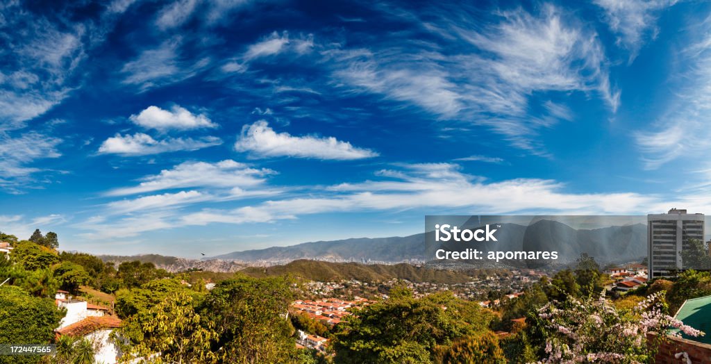 Eastern Caracas cloudscape panoramic city view at early morning Panoramic image of eastern Caracas city aerial view at late afternoon. Venezuela.  Showing El Avila mountain. 12 O'Clock Stock Photo