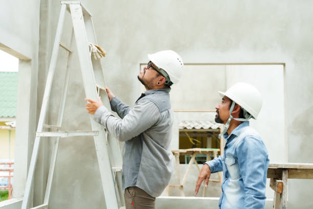 istock Two Asian men are construction engineers, looking at problem in newly built house, male technician climbed up steel stairs look at point high in ceiling, find correct correction. 1724478769