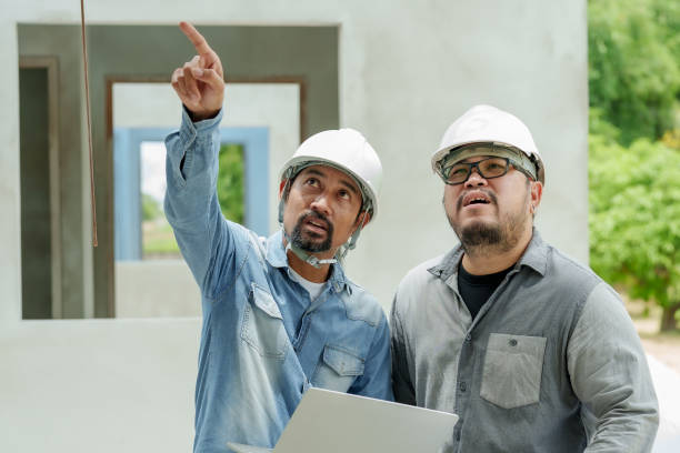 istock Engineer supervising work house builder is standing looking at shophouse plans, standing in front actual work site, two people wear safety helmets ensure safety while working on the construction site. 1724479295