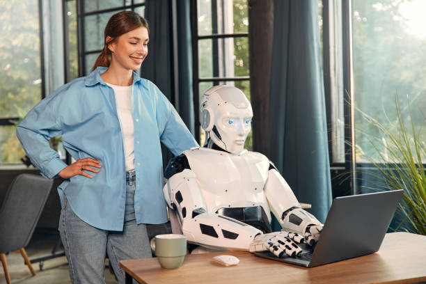 istock Robot and woman working on laptop in office 1724482036