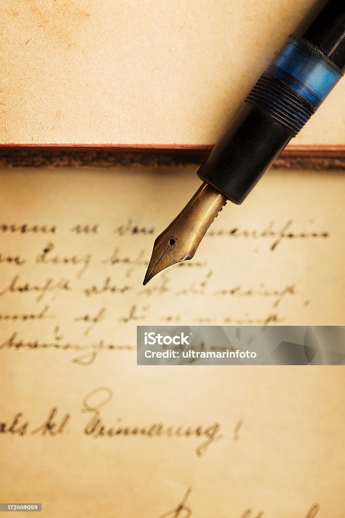 Vintage fountain pen and classical writing Antique fountain pen on old notepad - book with classical writing. Close-up.The grain and texture added. Selective focus. Very shallow depth of field for soft background. Scrapbook, diary, handwritten in 1922. Handwriting Stock Photo