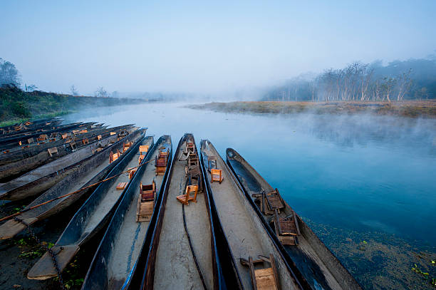 boats anchoring in river boats anchoring in river chitwan national park photos stock pictures, royalty-free photos & images
