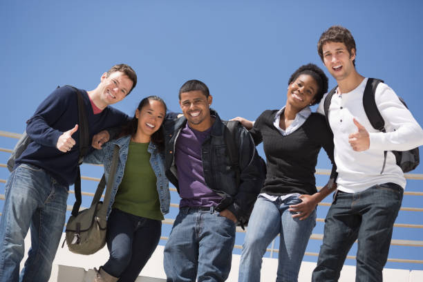 istock Multi-Ethnic Friends Standing Against Clear Sky 172449403
