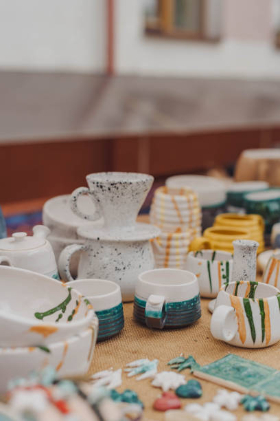 istock handmade ceramics, empty craft ceramic plates, mug, cup and bowls at a street fair or flea market or street Sunday market. Selective focus. 1724498160