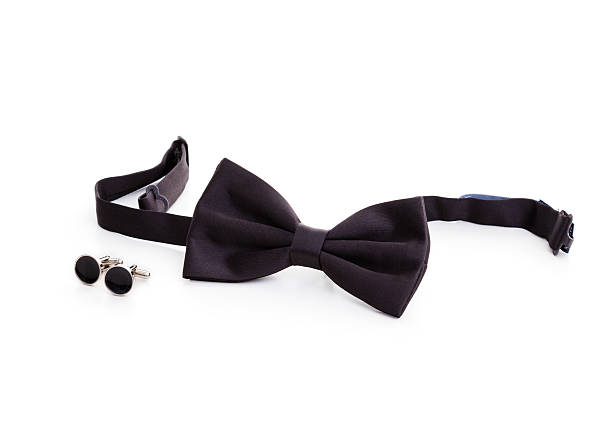 Cufflinks and tuxedo bow tie on the white background
