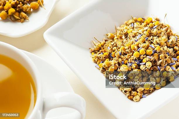 Chamomile And Lavender Tea Leaves Behind Cup Of Tea Stock Photo - Download Image Now