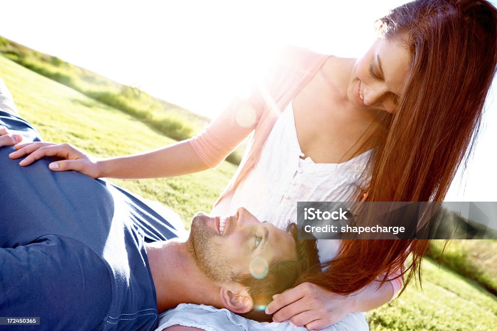 Enjoying an intimate moment A couple in a field with the boyfriend lying his girlfriend's lap while they share an intimate momenthttp://195.154.178.81/DATA/istock_collage/0/shoots/784956.jpg Adult Stock Photo