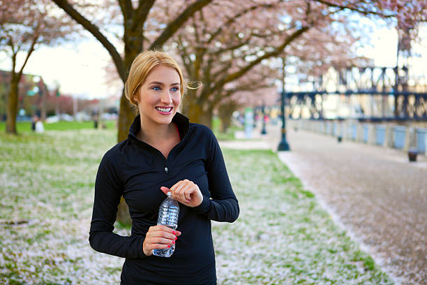istock Attractive young woman holding water bottle 172450583