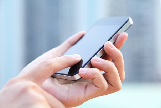 istock A woman using a large smartphone outdoors 172451131