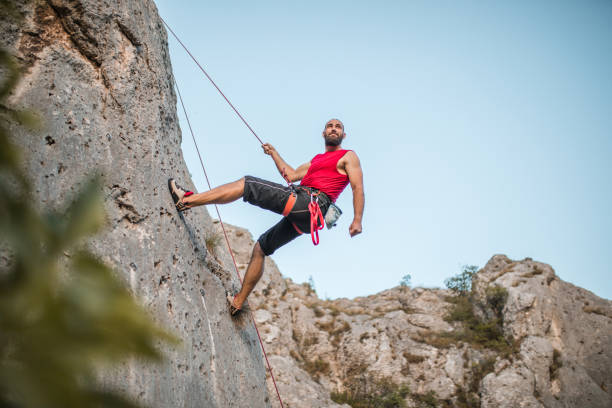 istock A bearded man overcomes extremely steep terrain by climbing a mountain during the day 1724512256