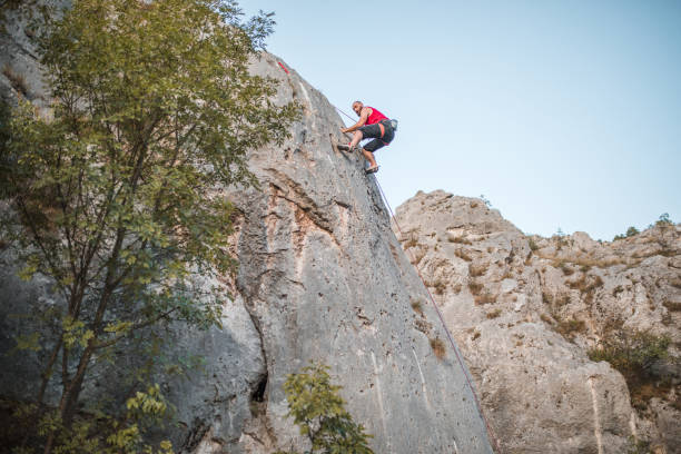 istock A concentrated male climber overcomes extremely steep terrain by climbing a mountain 1724521765
