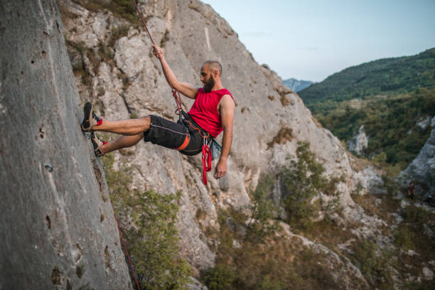 istock A concentrated man overcomes extremely steep terrain by climbing a mountain 1724522518