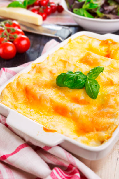 istock Homemade lasagna and green salad on a brightly lit table 172452317