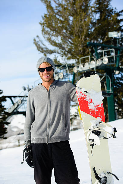 istock Snowboarder--Smiling Male with Snowboard 172452431