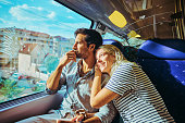 Young adult couple travelling by train in the south of France.