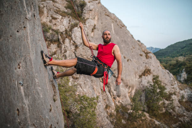 istock A focused man overcomes extremely steep terrain by climbing a mountain during the day 1724528044