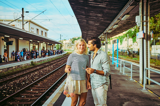 Young adult couple travelling by train in the south of France.