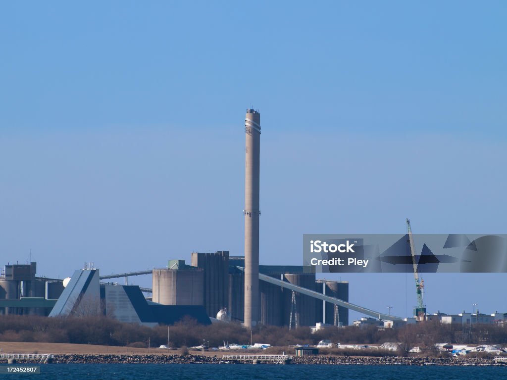 Cement plant Cement plant with smokestack and construction crane. Space for copy. Sweden Stock Photo