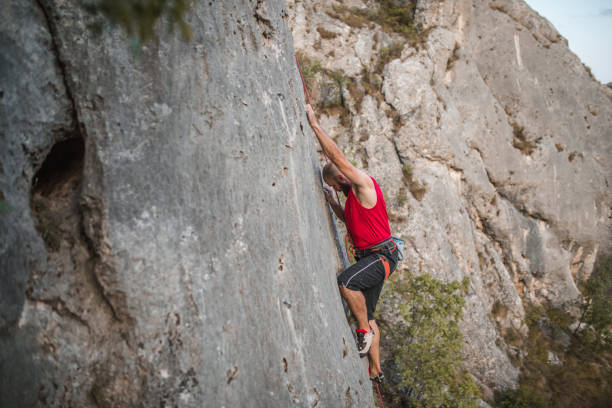istock A male climber climbs a mountain during the day on extreme terrain 1724529716