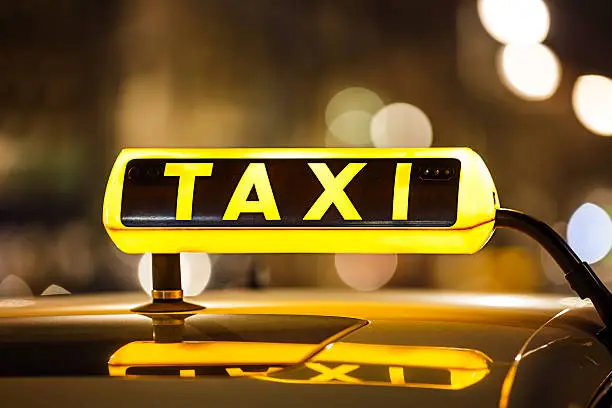 Illuminated Taxi sign on taxi car roof.