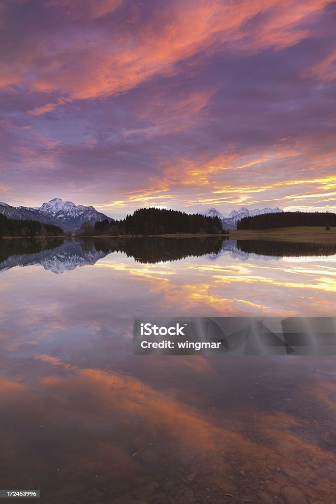 tranquil sunset at lake forggensee in bavaria - germany "tranquil sunset at lake bannwaldsee in bavaria - germany, view on mt. s" Germany Stock Photo