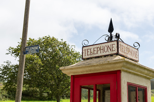 The Post Office in Port Stanley, Falkland Islands, with two red British-style telephone booths and a red post boox. Also incorporating the Philatelic Bureau.